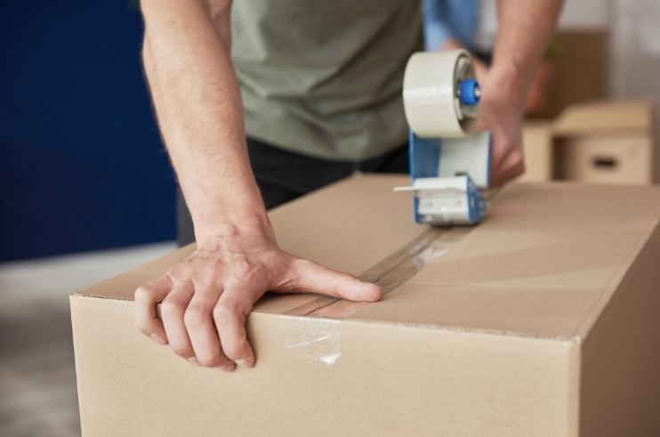 cardboard box being taped shut